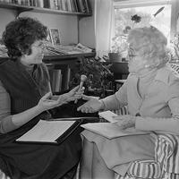Two women talking while being recorded with a microphone.