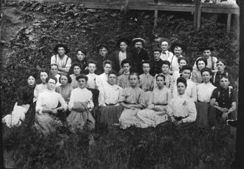 Group of female and male workers posing outside for group photo