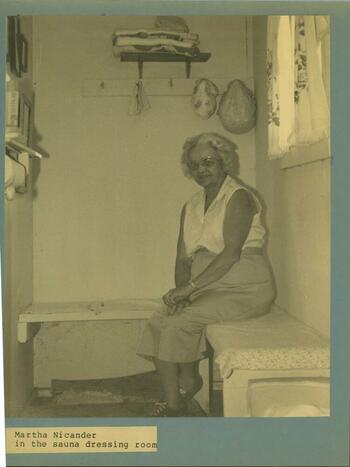 an older Finnish woman sits in a sauna