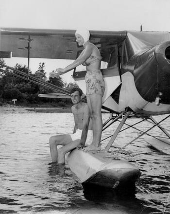 Margaret and George Potts take a break on one of Margaret's seaplanes. 