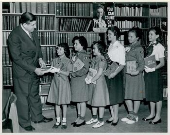 Hermann F. Robinton, the Seaford Public Library's first director, with Seaford Girl Scouts (left to right) Sharon Baras, Susan Friedman, Georgianna McCahill, Barbara Gross, Margaret Fischer, and Nancy Fowler. (1958)