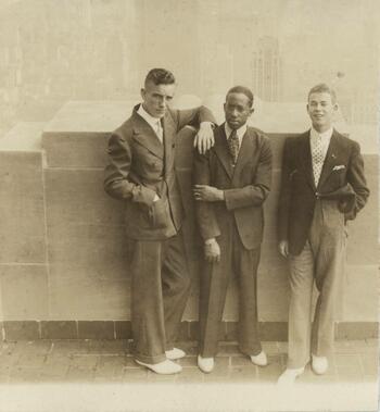 three young men Leaning Against a Wall