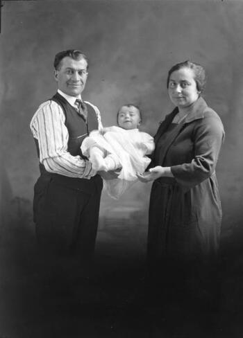 Two parents holding baby