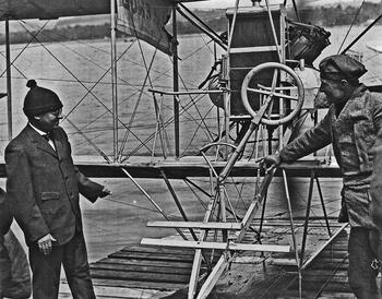 James Ward Packard posing with seaplane